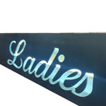 Load image into Gallery viewer, Neon sign with the word 'Ladies' on a black background
