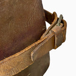 Load image into Gallery viewer, A close-up of a brown leather apron strap with a metal buckle, attached to a dark brown leather apron, shown against a plain white background.
