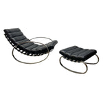 Load image into Gallery viewer, A mid-century modern lounge chair and matching ottoman set with black leather upholstery and curved tubular metal bases, shown on a plain white background.
