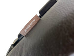 Load image into Gallery viewer, Close-up of a dark textured leather or faux-leather product with a small brown leather tag reading 'ALMIDECOR' on a white background.

