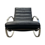 Load image into Gallery viewer, A modern black leather lounge chair with a curved chrome metal frame, shown against a plain white background.
