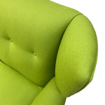 Load image into Gallery viewer, Close-up of a bright lime green upholstered chair or sofa section, showing the armrest, button-tufted back cushion, and fabric texture against a plain white background.
