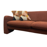 Load image into Gallery viewer, A mid-century modern terracotta brown bouclé sofa with two decorative throw pillows featuring a geometric pattern in beige, brown, and mustard yellow, shown against a plain white background.
