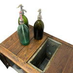 Load image into Gallery viewer, Three vintage glass soda bottles with metal gooseneck dispensers resting on a rustic wooden table with a built-in sink opening.
