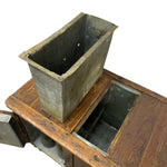 Load image into Gallery viewer, A rectangular corrugated metal dust collector filter basket with a gray finish, shown resting on a vintage wooden cabinet with an open door.
