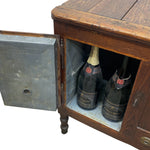 Load image into Gallery viewer, A rustic wooden chest of drawers with an open metal door, revealing two champagne bottles inside, isolated on a white background.
