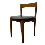 Load image into Gallery viewer, A mid-century modern wooden dining chair with a warm brown wood frame and a black upholstered seat cushion, shown against a plain white background.
