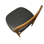 Load image into Gallery viewer, A mid-century modern style dining chair with a dark gray upholstered seat and a curved natural wood frame, shown from an elevated angle against a plain white background.
