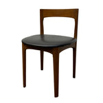Load image into Gallery viewer, A mid-century modern wooden dining chair with a warm brown wood frame and a black upholstered seat, shown against a plain white background.
