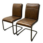 Load image into Gallery viewer, Two matching brown leather dining chairs with ribbed vertical backrests and cantilever metal frames, shown on a plain white background.
