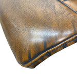 Load image into Gallery viewer, Close-up of a brown faux-leather or leather product corner showing the textured grain and dark contrast stitching against a white background.
