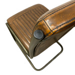 Load image into Gallery viewer, Close-up of a brown leather chair or stool with a ribbed seat, dark metal frame, and a round black adjustment knob, shown on a white background.
