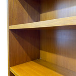 Load image into Gallery viewer, Close-up of the interior corner of a wooden bookshelf with two shelves, showing a warm medium-brown wood grain finish and visible mounting holes.
