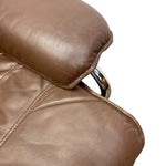 Load image into Gallery viewer, Close-up of a brown leather chair armrest and backrest with a polished chrome metal frame, isolated on a white background.
