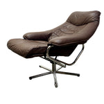 Load image into Gallery viewer, A mid-century modern lounge chair with an attached footrest, upholstered in dark brown leather with a polished chrome metal base, shown against a plain white background.
