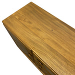 Load image into Gallery viewer, Close-up of a wooden cabinet or sideboard with a warm golden-brown wood grain finish and small round drawer pulls, shown on a plain white background.
