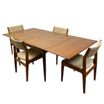 Load image into Gallery viewer, A mid-century modern wooden dining table set with four upholstered chairs, shown on a solid white background.
