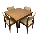 Load image into Gallery viewer, A mid-century modern 5-piece dining set featuring a square wooden table and four matching armchairs with beige upholstered seats and backs, shown on a solid white background.
