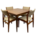 Load image into Gallery viewer, A mid-century modern 5-piece dining set featuring a square wooden table and four matching armchairs with beige upholstered seats and backs, shown on a solid white background.
