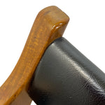 Load image into Gallery viewer, Close-up detail of a wooden armrest with a glossy medium-brown finish meeting a black leather upholstered section on a white background.
