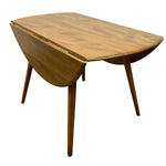 Load image into Gallery viewer, A mid-century modern wooden drop-leaf table with a warm medium-brown wood grain finish, shown on a solid white background.
