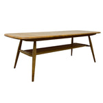 Load image into Gallery viewer, A mid-century modern wooden coffee table with a rounded rectangular top, angled slatted legs, and a lower shelf, shown on a plain white background.
