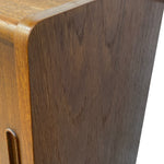 Load image into Gallery viewer, Close-up of a wooden cabinet corner showing a warm medium-brown wood grain finish and rounded edges against a white background.
