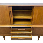 Load image into Gallery viewer, Mid-century modern wooden sideboard cabinet with a warm walnut finish, featuring two upper doors with open shelving and three lower drawers with pull handles, shown against a white background.
