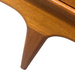Load image into Gallery viewer, Close-up of a mid-century modern wooden furniture piece, showing a tapered wooden leg and warm medium-brown wood grain against a white background.
