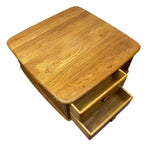 Load image into Gallery viewer, A mid-century modern wooden side table with a square top, rounded corners, and one open drawer, shown from an elevated angle on a white background.
