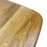 Load image into Gallery viewer, Close-up of a wooden tabletop corner with rounded edges and visible wood grain on a white background.

