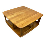 Load image into Gallery viewer, A square wooden coffee table with rounded corners and a lower shelf, shown from an elevated angle on a plain white background.
