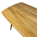Load image into Gallery viewer, Close-up of a light oak wood table top with rounded corners and a glossy finish, showing the natural wood grain texture and a small portion of the tapered wooden leg against a white background.
