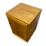 Load image into Gallery viewer, A square wooden cabinet or side table with a warm honey-toned wood grain finish and a small round metal pull handle, shown on a plain white background.
