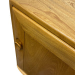 Load image into Gallery viewer, Close-up of a wooden cabinet corner with a curved front, a round wooden knob, and a glossy finish on a white background.
