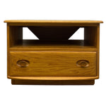 Load image into Gallery viewer, A mid-century modern wooden side table with a single drawer featuring oval pulls, set against a plain white background.
