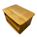 Load image into Gallery viewer, A mid-century modern wooden nightstand or end table with a warm honey-toned wood finish, featuring a top surface, a lower drawer with round wooden pulls, and a curved front edge, shown on a plain white background.
