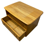 Load image into Gallery viewer, A small wooden storage cabinet or organizer with one open drawer, shown on a plain white background. The piece of furniture has a warm honey-toned wood finish with visible grain patterns.
