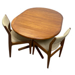 Load image into Gallery viewer, A mid-century modern three-piece dining set featuring an oval wooden table and two matching chairs with beige upholstered seats, shown on a solid white background.
