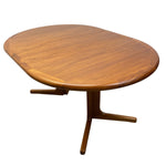 Load image into Gallery viewer, A mid-century modern wooden dining table with an asymmetrical, rounded oval top and a curved pedestal base, shown on a plain white background.
