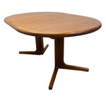 Load image into Gallery viewer, A mid-century modern wooden dining table with an oval-shaped top and a curved pedestal base, shown on a plain white background.

