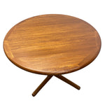 Load image into Gallery viewer, A round wooden coffee table with a warm medium-brown finish and a four-leg star base, shown from an elevated angle on a white background.

