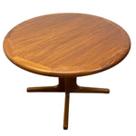 Load image into Gallery viewer, A round wooden coffee table with a warm medium-brown finish and a star-shaped pedestal base, shown against a plain white background.

