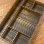 Load image into Gallery viewer, A rectangular wooden organizer tray with multiple compartments, shown close-up on a matching wood surface.
