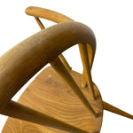 Load image into Gallery viewer, Close-up of a wooden chair showing the curved backrest, spindles, and circular seat on a plain white background.
