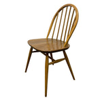 Load image into Gallery viewer, A mid-century modern wooden chair with a curved spindle backrest, a rounded seat, and tapered legs, shown against a plain white background.
