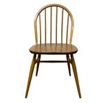 Load image into Gallery viewer, A mid-century modern wooden dining chair with a spindle back, oval seat, and tapered legs, shown against a plain white background.
