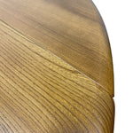Load image into Gallery viewer, Close-up of a curved wooden tabletop showing the wood grain and finish against a white background.
