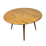 Load image into Gallery viewer, A round wooden extendable dining table with a warm medium-brown wood grain finish and four tapered legs, shown on a plain white background.
