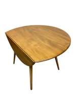Load image into Gallery viewer, A mid-century modern wooden side table with a rounded, organic triangular top and four tapered legs, shown on a plain white background.
